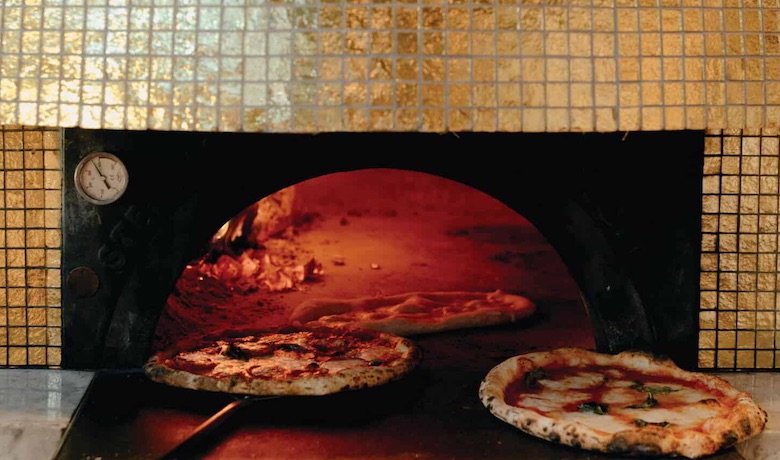 A screenshot of pizzas being baked in an oven at La Pizza e La Pasta restaurant in in Park MGM Hotel and Casino Las Vegas.
