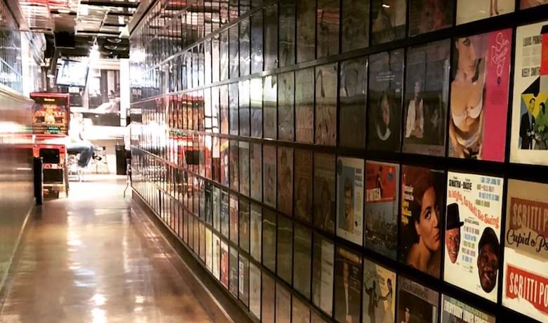 A screenshot of the hallway with records on the wall that leads to Secret Pizza in the Cosmopolitan Hotel and Casino Las Vegas.